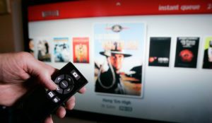 Netflix customer Arthur Michelson demonstrates the online Netflix movie service Roku at his home in Palo Alto, Calif., Thursday, July 23, 2009. Netflix Inc.'s second-quarter profit coasted past expectations as recession-weary customers continued to embrace its DVD-by-mail and streaming movie service. (AP Photo/Paul Sakuma)