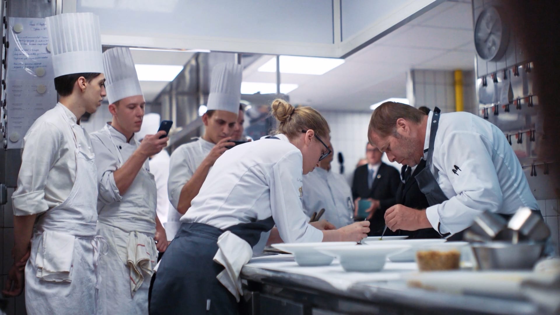 Le Taillevent (Paris)_Chef David Kinch plating with his California team as the French cooks observe_A Chef's Voyage