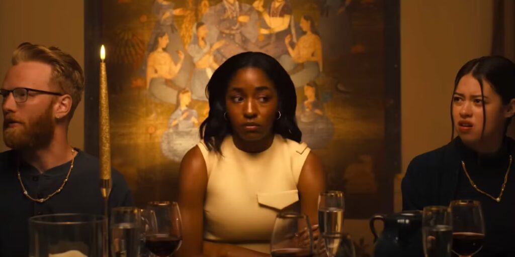 ayo-edebiri-sits-in-between-two-cult-members-at-a-dinner-table-in-opus